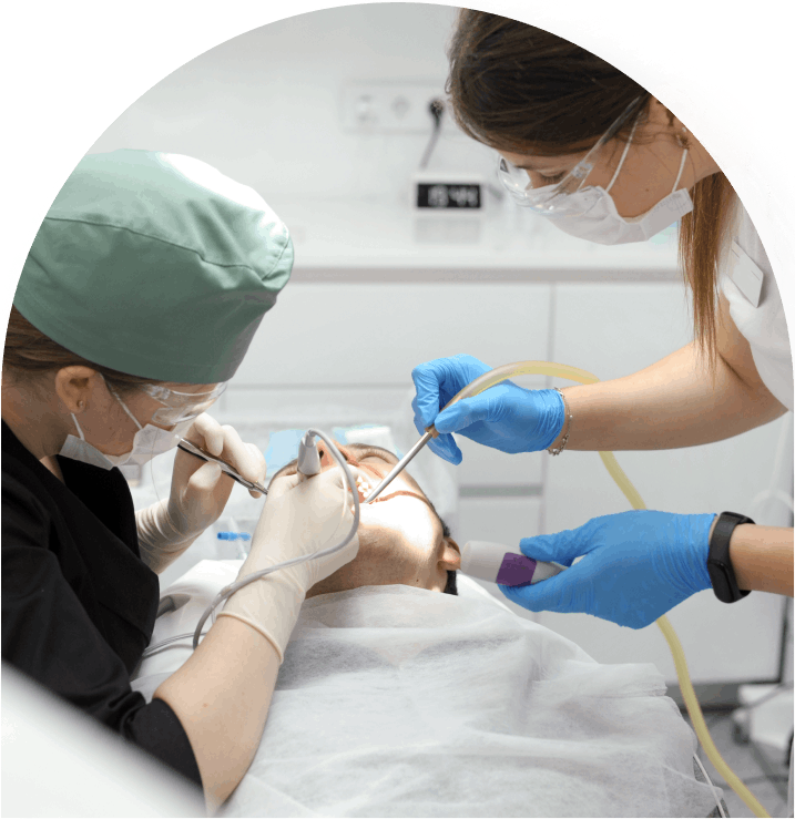 Attractive young woman in stomatology clinic with female dentist